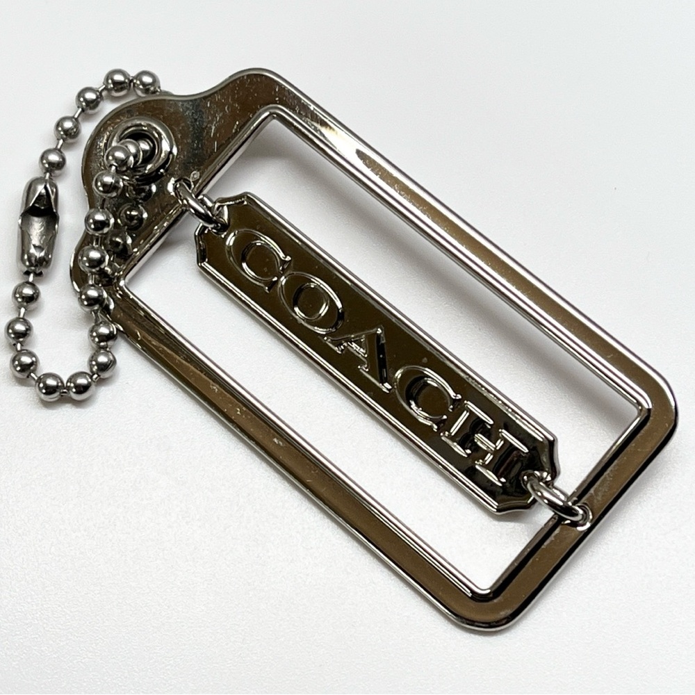 Coach Silver metal Pivoting Hang Tag EUC